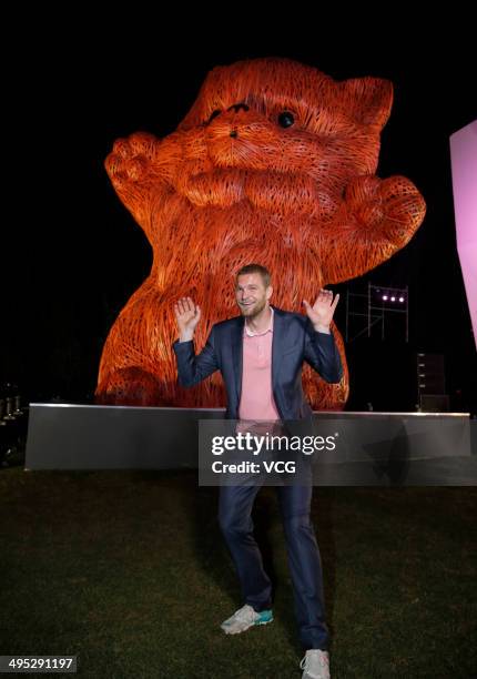 Dutch artist Florentijn Hofman poses with his latest artwork the 'Pink Kitten', which is made of strips of bamboo, during the Shanghai Design Week at...