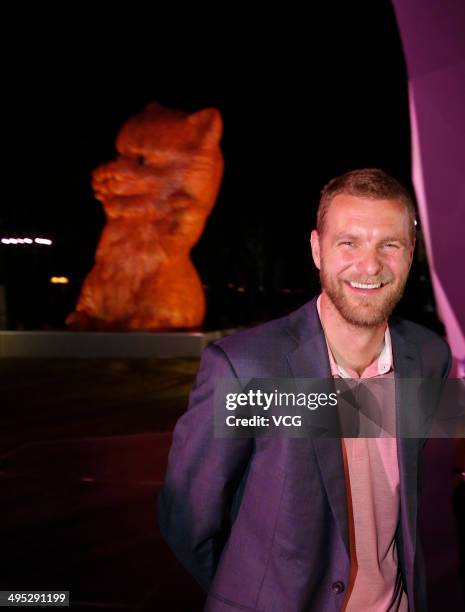 Dutch artist Florentijn Hofman poses with his latest artwork the 'Pink Kitten', which is made of strips of bamboo, during the Shanghai Design Week at...