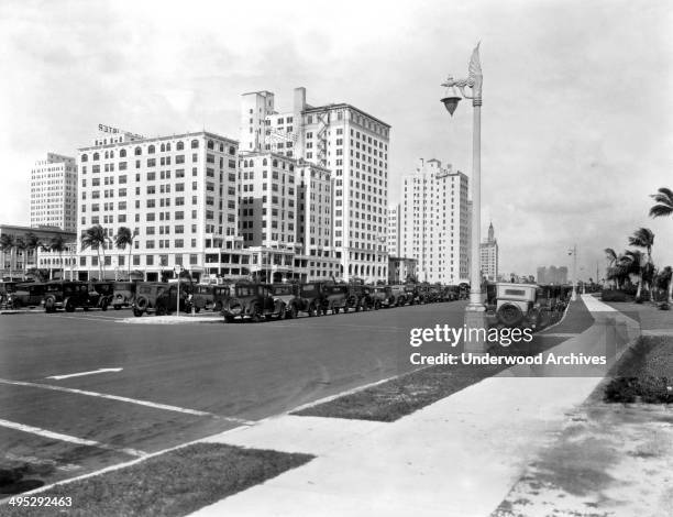 Looking north on Biscayne Boulevard at Flagler Street in Miami with the McAllister Hotel at left front and Bayfront Park to the right, Miami,...