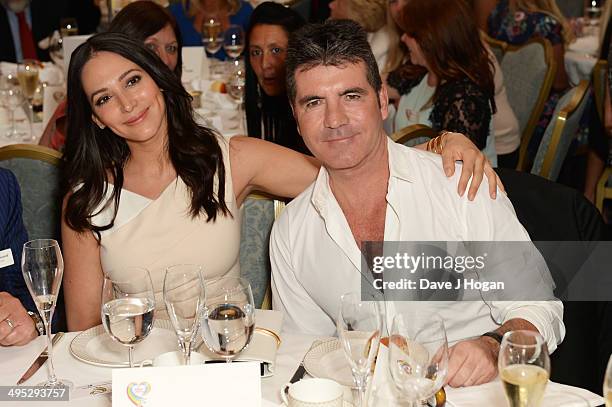 Lauren Silverman and Simon Cowell attend the Health Lottery Tea Party at The Savoy on June 2, 2014 in London, England.