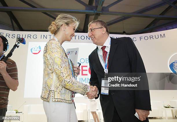 In this handout photo provided by Slava Korolev, Global Strategic Consultant Corinna Sayn-Wittgenstein greets Chairman, The Boston Consulting Group...