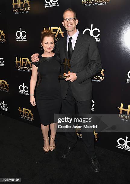 Actress Amy Poehler and director Pete Docter, winner of the Hollywood Animation Award for 'Inside Out', pose in the press room during the 19th Annual...