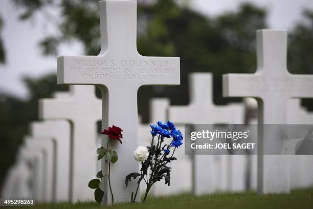 Picture taken on June 2, 2014 shows flowers on a grave at the US cemetery in Colleville-sur-Mer, ahead of the 70th anniversary of the D-Day landings...