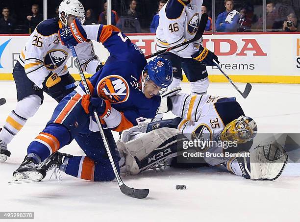 Anders Lee of the New York Islanders attempts to control the puck in front oif Linus Ullmark of the Buffalo Sabres during the second period at the...