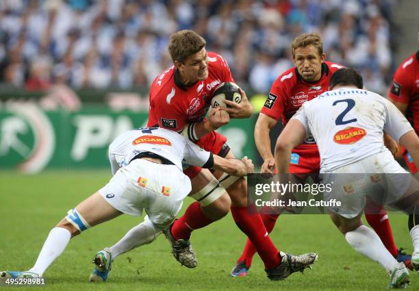 Juan Smith of RC Toulon is tackled by Yannick Caballero of Castres Olympique during the Top 14 Final between RC Toulon and Castres Olympique at Stade...