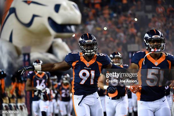 Kenny Anunike of the Denver Broncos runs onto the field before the game. The Denver Broncos played the Green Bay Packers at Sports Authority Field at...