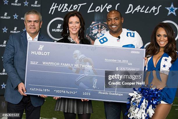 Ricardo Guadalupe, Charlotte Jones Anderson and Darren Woodson present a check to the Warrior Family Network as Hublot unveils the Big Bang Dallas...