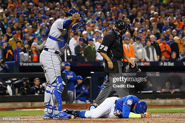 Yoenis Cespedes of the New York Mets lies on the ground after fouling the ball off of his leg in the sixth inning against the Kansas City Royals...