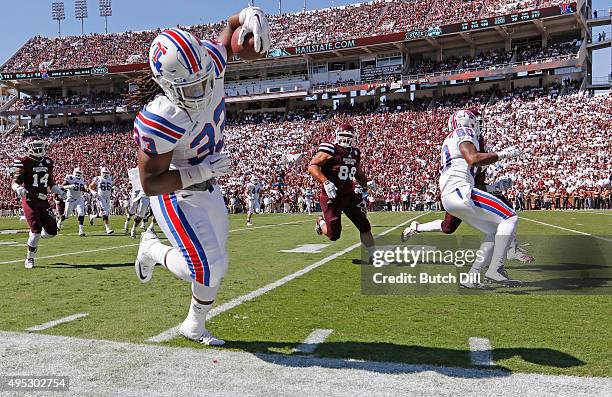 Tight end Ricky Jones of the Louisiana Tech Bulldogs tip toes down the sideline as he carries the ball during the second quarter of an NCAA college...