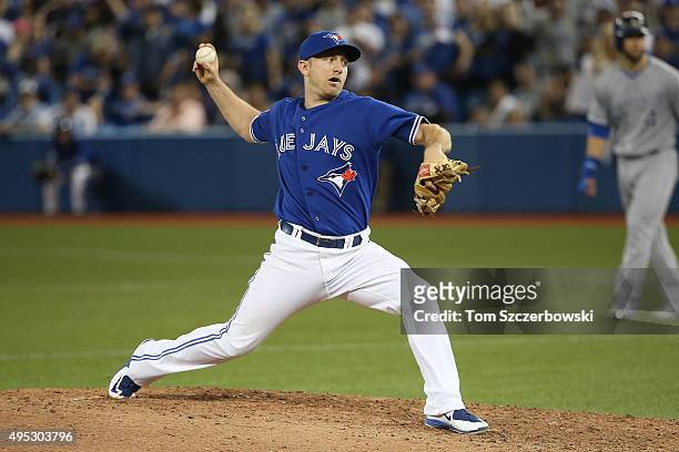 Cliff Pennington of the Toronto Blue Jays delivers a pitch in the ninth inning against the Kansas City Royals during game four of the American League...