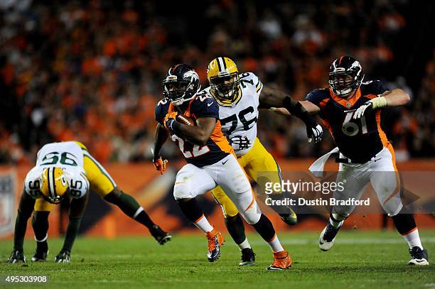 Anderson of the Denver Broncos runs the ball for a third quarter touchdown against Mike Daniels of the Green Bay Packers at Sports Authority Field at...