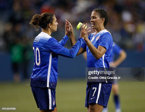 Shannon Boxx of the United States is congratulated by Carli Lloyd as she is removed from the match in the first half against Brazil at CenturyLink...