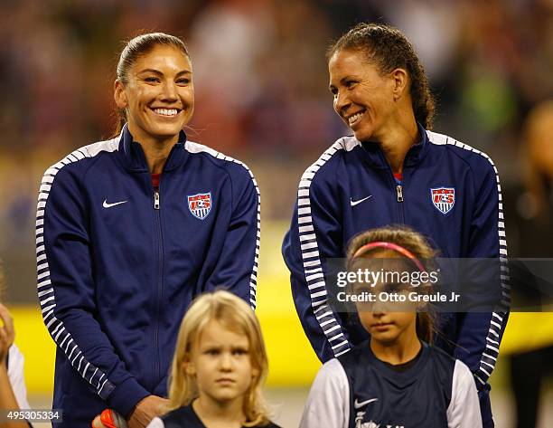 Shannon Boxx and Hope Solo of the United States look on during team introductions prior to the match against Brazil at CenturyLink Field on October...