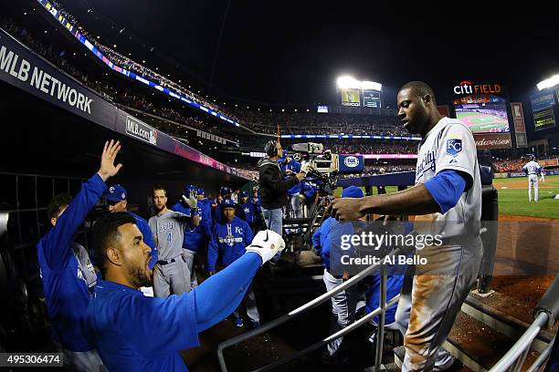 Lorenzo Cain of the Kansas City Royals celebrates with his teammates in the dugout after scoring a run off of a double hit by Eric Hosmer of the...