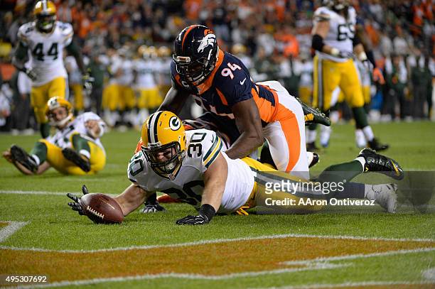 John Kuhn of the Green Bay Packers tries to recover a fumble by Aaron Rodgers of the Green Bay Packers. The play resulted in a safety for the...