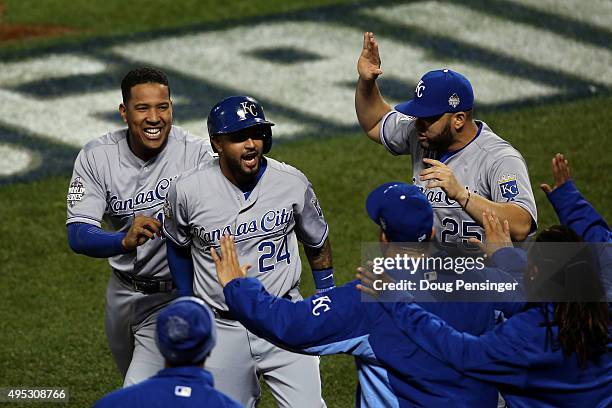 Christian Colon of the Kansas City Royals celebrates with his teammates after scoring in the 12th inning against the New York Mets during Game Five...