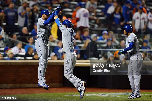 Ben Zobrist of the Kansas City Royals celebrates with Christian Colon and Alcides Escobar after scoring off of a three run RBI double hit by Lorenzo...