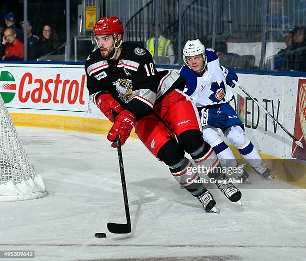Brian Lashoff of the Grand Rapids Griffins controls the puck past Kasperi Kapanen of the Toronto Marlies during AHL game action on October 30, 2015...