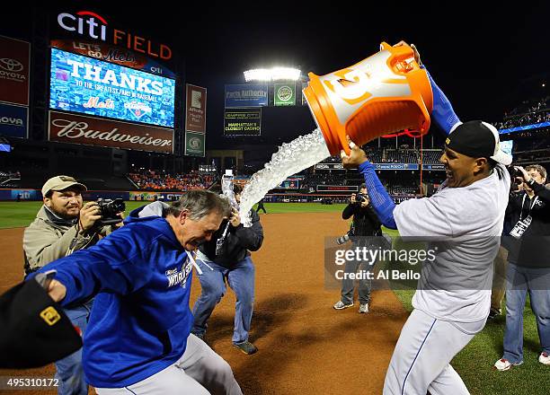 Salvador Perez of the Kansas City Royals douses manager Ned Yost of the Kansas City Royals after the Kansas City Royals defeat the New York Mets in...