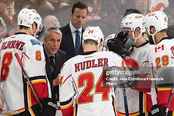 Head Coach Bob Hartley of the Calgary Flames talks to Joe Colborne, x24n\ and Deryk Engelland during an NHL game against the Ottawa Senators at...