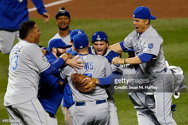 Wade Davis of the Kansas City Royals and Drew Butera of the Kansas City Royals celebrate with teammates after defeating the New York Mets to win Game...
