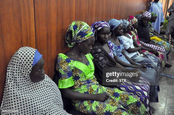 Schoolgirls who have escaped from Boko Haram kidnappers in the village of Chibok, sit at the Government house to speak with State Governor Kashim...