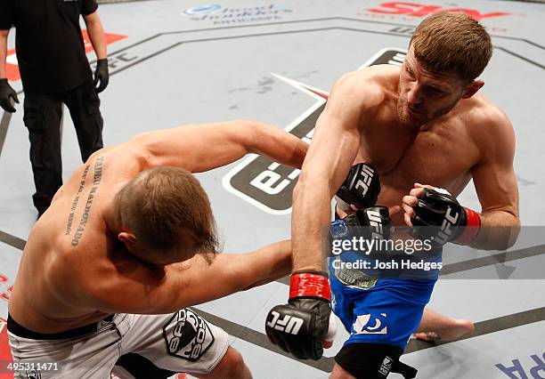 Stipe Miocic punches Fabio Maldonado in their heavyweight fight during the UFC Fight Night event at the Ginasio do Ibirapuera on May 31, 2014 in Sao...