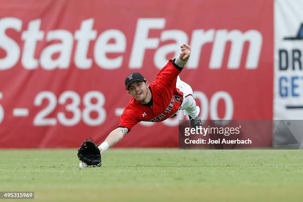 Todd Ritchie of the Texas Tech Red Raiders is unable to catch the ball hit by Tyler Palmer of the Miami Hurricanes in the eighth inning during the...