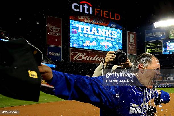 Salvador Perez of the Kansas City Royals douses manager Ned Yost of the Kansas City Royals after the Kansas City Royals defeat the New York Mets in...