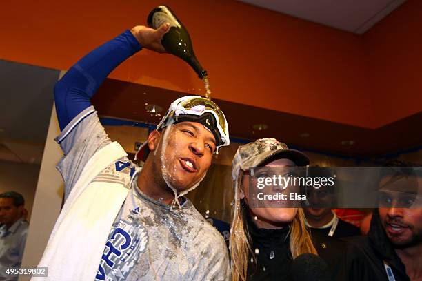 Salvador Perez of the Kansas City Royals celebrates in the clubhouse with MLB sportscaster Heidi Watney after defeating the New York Mets to win Game...