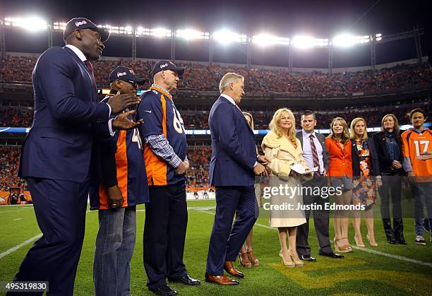 Shannon Sharpe, Floyd Little, Gary Zimmerman and John Elway present Annabel Bowlen with a ring at the induction of Broncos Owner Pat Bowlen into the...