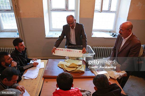 The president of a polling station shows the polling card on November 1, 2015 in Diyarbakir, Turkey. Polls have opened in Turkey's second general...