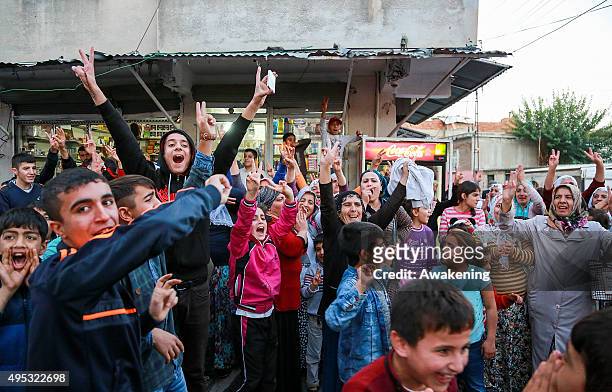 People cheers near a polling station on November 1, 2015 in Diyarbakir, Turkey. Polls have opened in Turkey's second general election this year, with...