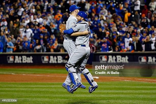 Wade Davis of the Kansas City Royals celebrates with Drew Butera of the Kansas City Royals after defeating the New York Mets to win Game Five of the...