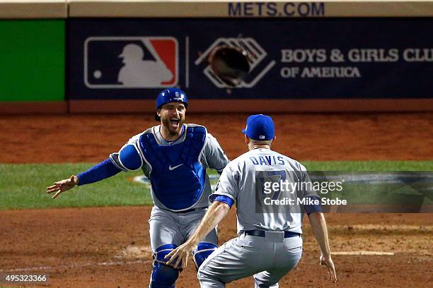 Wade Davis of the Kansas City Royals celebrates with Drew Butera of the Kansas City Royals after defeating the New York Mets to win Game Five of the...
