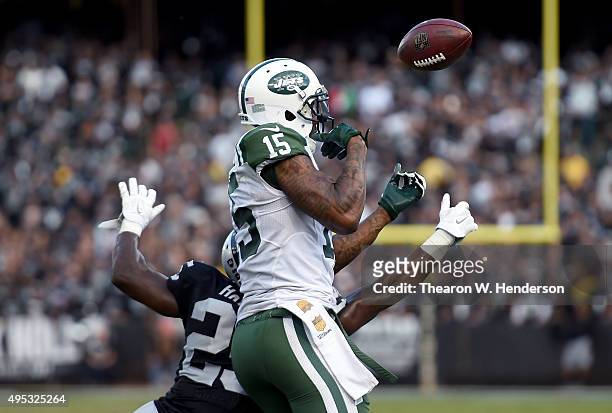 Hayden of the Oakland Raiders breaks up the pass to wide receiver Brandon Marshall of the New York Jets during the fourth quarter of an NFL football...