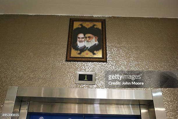Portraits of the late Ayatollah Khomeini and Iran's current supreme leader Ayatollah Khamenei gaze hang over an elevator in the new Isfahan City...