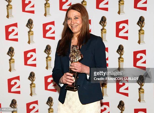 Actress Valerie Dreville poses with the "best actress in a public play" Moliere Theater Award for "Les Revenants" during the 26th Molieres theatre...