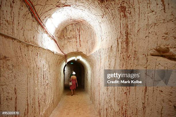 Vistors walk through the underground tunnels in Tom's Working Opal Mine on October 22, 2015 in Coober Pedy, Australia. Tom's Working Opal Mine is an...