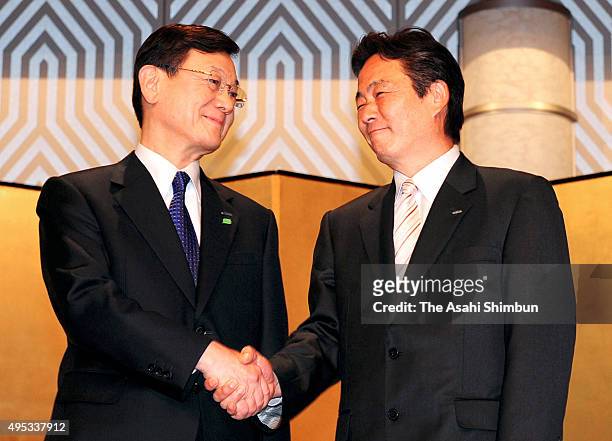 Panasonic President Fumio Otsubo and Sanyo President Seiichiro Sano shake hands during a press conference announcing their merger on November 7, 2008...
