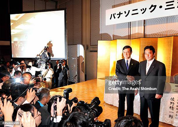 Panasonic President Fumio Otsubo and Sanyo President Seiichiro Sano shake hands during a press conference announcing their merger on November 7, 2008...