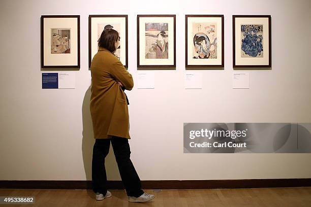 Visitor views a series of woodblock prints titled 'Beautiful Women' during a press preview for the Victoria and Albert Museum's new Toshiba Gallery...