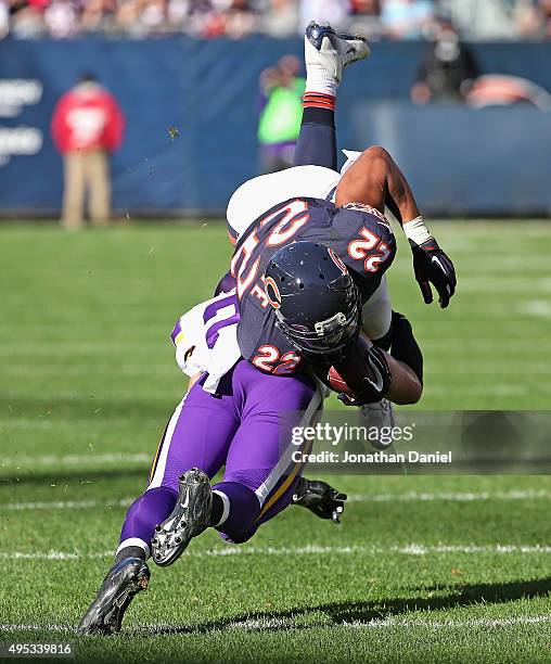 Matt Forte of the Chicago Bears is upended by Harrison Smith of the Minnesota Vikings at Soldier Field on November 1, 2015 in Chicago, Illinois. The...