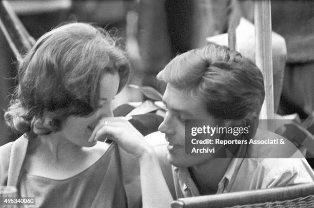 French actor Alain Delon chatting and smiling with German-born French actress Romy Schneider in a café on Via Veneto. Rome,