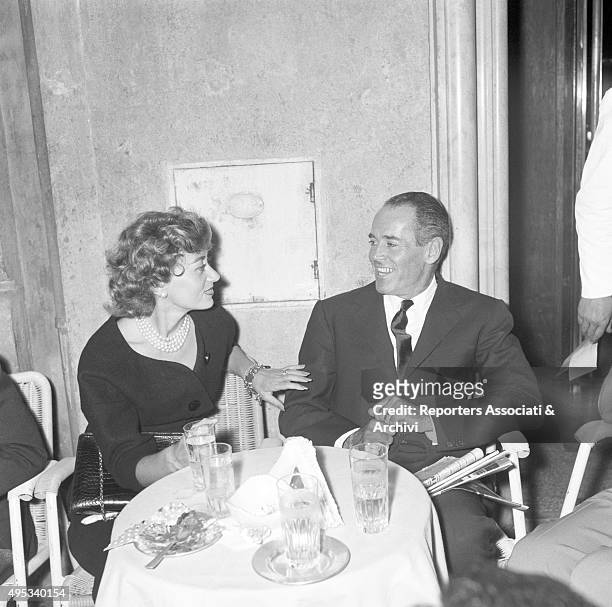 American actor Henry Fonda looking into his wife Afdera Franchetti's eyes seated at a table at Casina delle Rose of Via Veneto. Rome, 18th September...