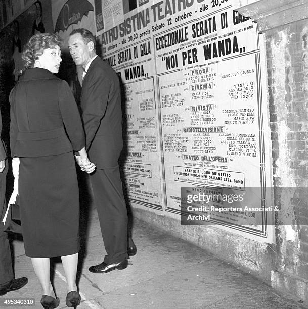 American actor Henry Fonda and his wife and Italian baroness Afdera Franchetti walking in the street by night after an opening night at Eliseo...