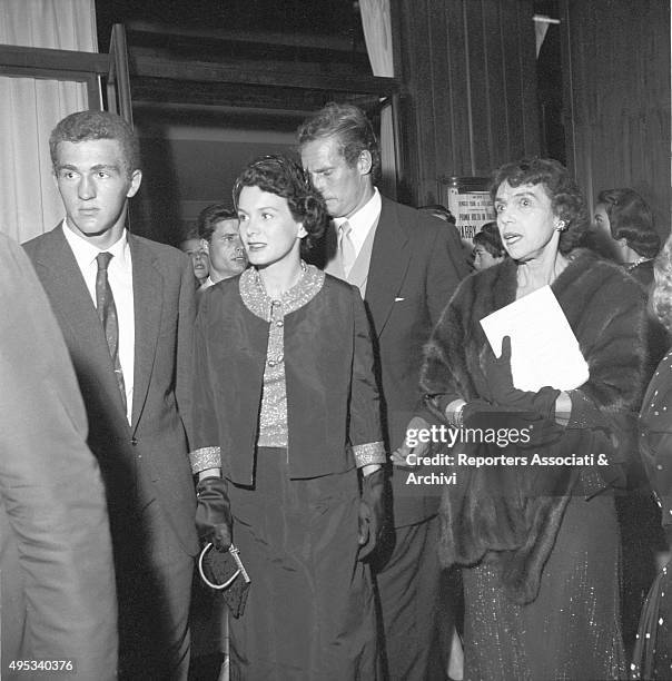 American actor Charlton Heston and his wife and American actress Lydia Clarke getting with some unidentified people the Sistina Theatre for Harry...