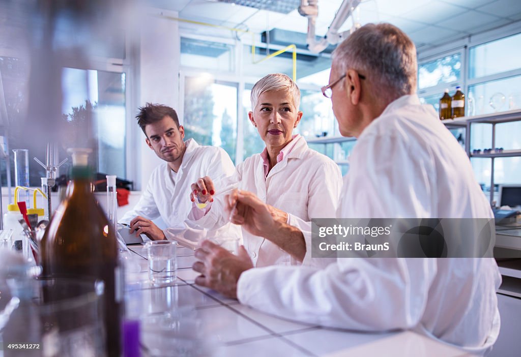 Team of chemists cooperating while working on a new research.