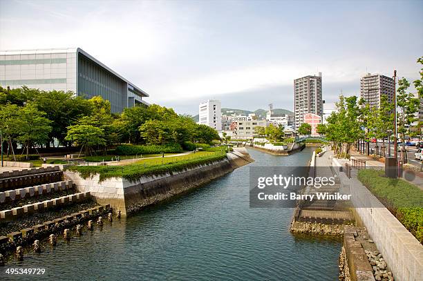 canal park alongside modern city buildings - barry park foto e immagini stock