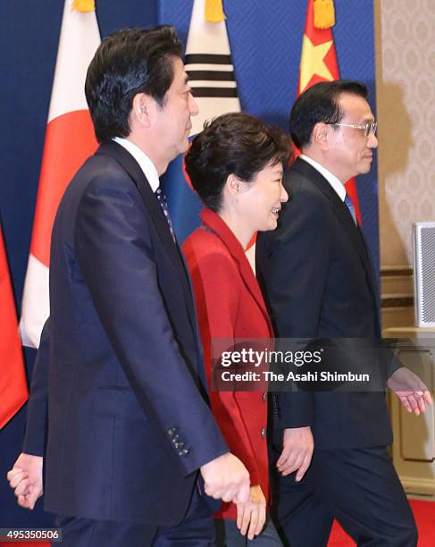 Japanese Prime Minister Shinzo Abe , South Korean President Park Geun-hye and Chinese Premier Li Keqiang leave a photo session ahead of the...